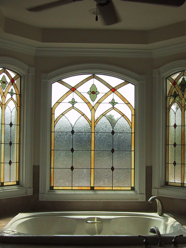 glass accents ironwork stained glass window over bathtub