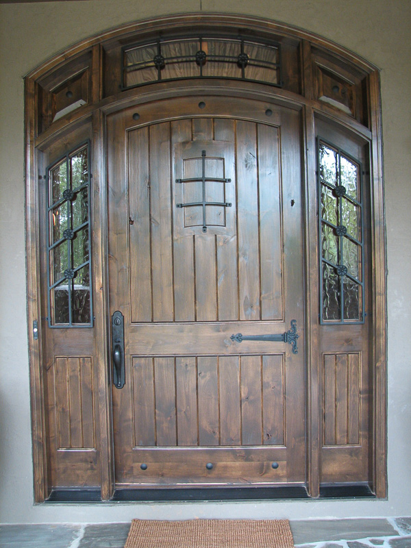 knotty alder wood entry door sidelights transom iron grill clavos